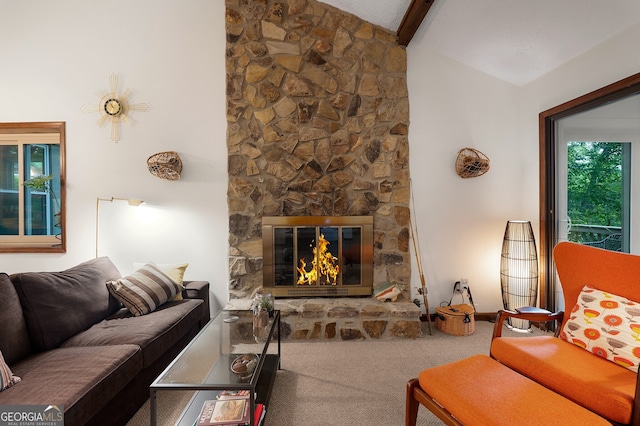 carpeted living room featuring lofted ceiling with beams and a stone fireplace