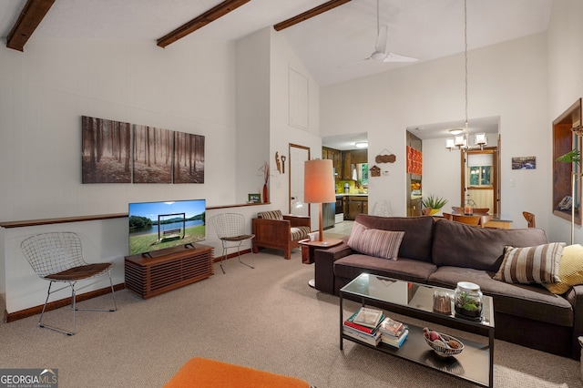 carpeted living room featuring an inviting chandelier, beam ceiling, and high vaulted ceiling