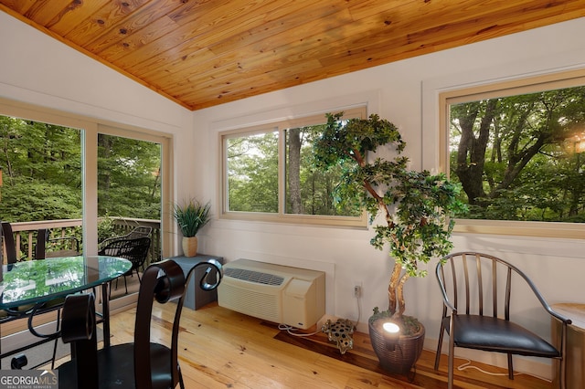 sunroom / solarium featuring lofted ceiling, a healthy amount of sunlight, and wood ceiling