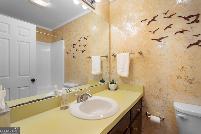 bathroom with crown molding, toilet, and vanity