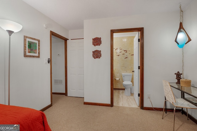 carpeted bedroom with ensuite bath