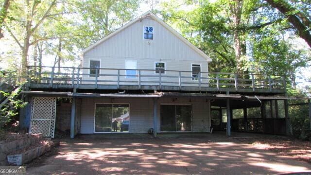 rear view of house with a wooden deck