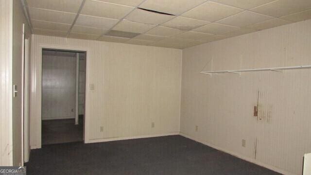 unfurnished room with a drop ceiling