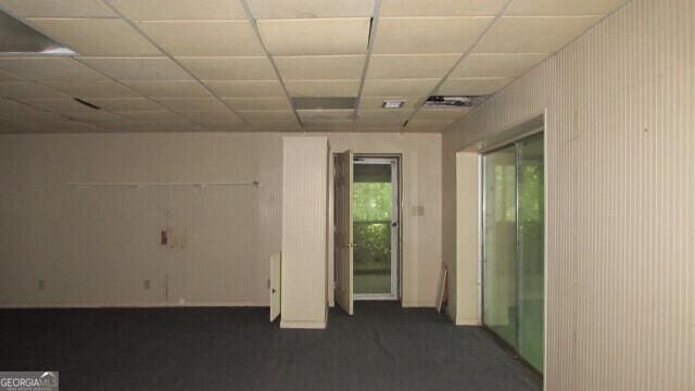 empty room featuring a paneled ceiling