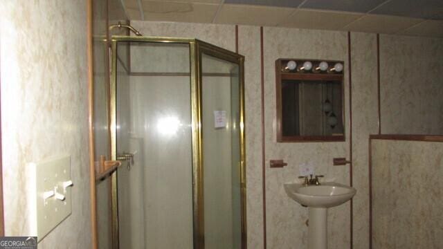 bathroom featuring a shower with shower door