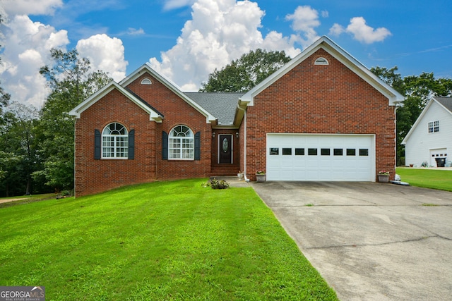 view of front of house with brick siding, driveway, an attached garage, and a front lawn