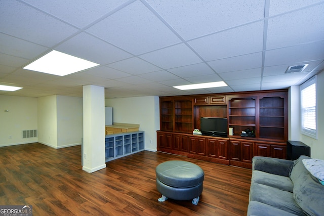 home office with visible vents, baseboards, a paneled ceiling, and dark wood-style floors
