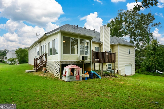 back of property featuring a shingled roof, a sunroom, a yard, an attached garage, and a chimney