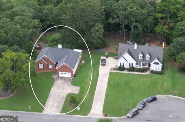 birds eye view of property with a forest view