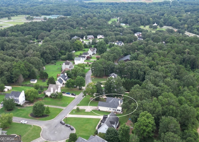 aerial view featuring a view of trees and a residential view