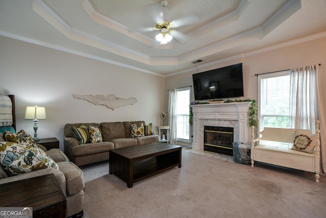 living area featuring carpet flooring, crown molding, and a healthy amount of sunlight