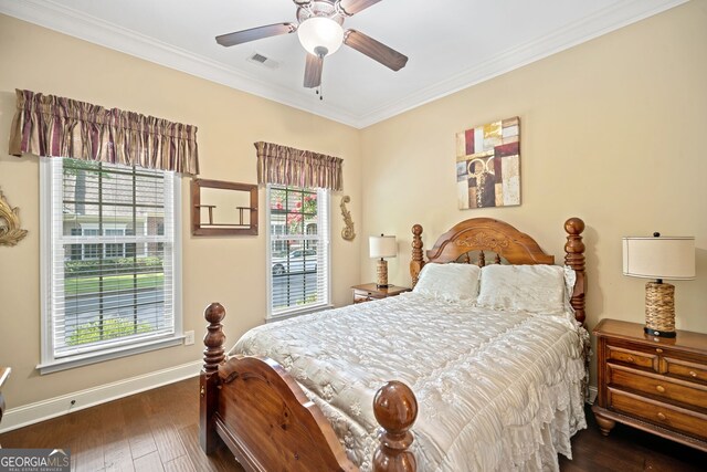 bedroom featuring multiple windows, ceiling fan, dark wood-type flooring, and crown molding