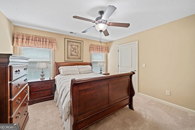 bedroom with ceiling fan and light carpet