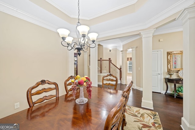 dining room featuring decorative columns, crown molding, dark wood-type flooring, and a chandelier