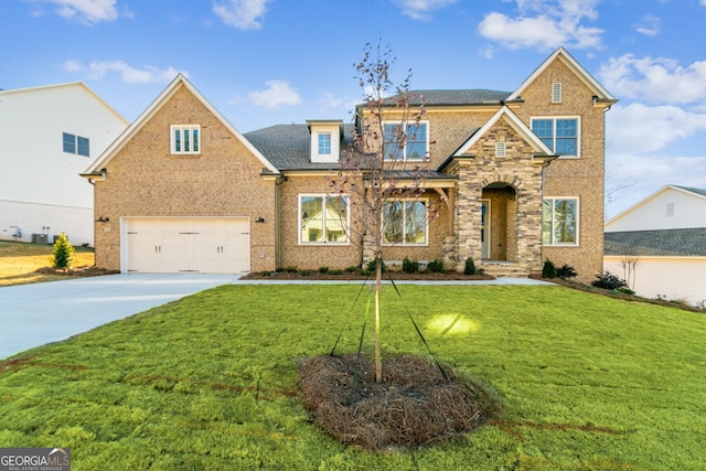 view of front of house with a garage and a front lawn