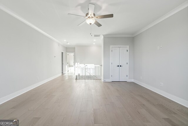 spare room with light hardwood / wood-style floors, ceiling fan, and crown molding