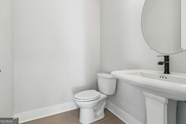 bathroom with wood-type flooring and toilet