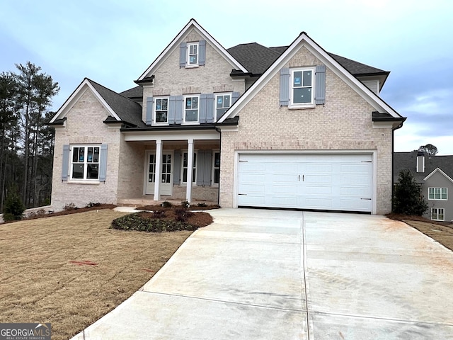 craftsman-style home featuring a porch, a garage, and a front yard