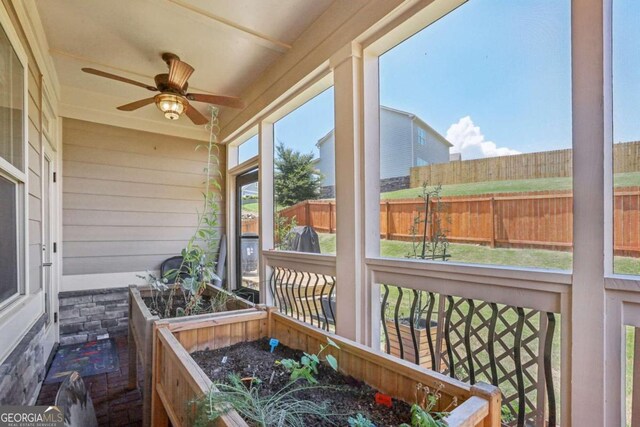 sunroom featuring ceiling fan