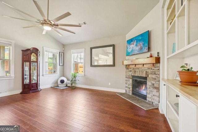 living room with vaulted ceiling, ceiling fan, a fireplace, and dark hardwood / wood-style floors