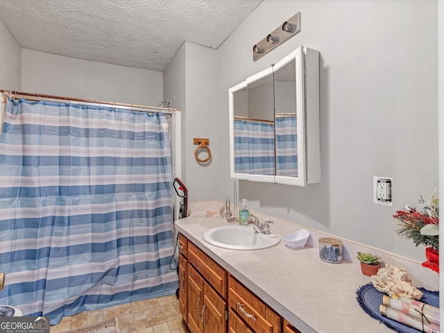 bathroom with vanity, a textured ceiling, and a shower with curtain