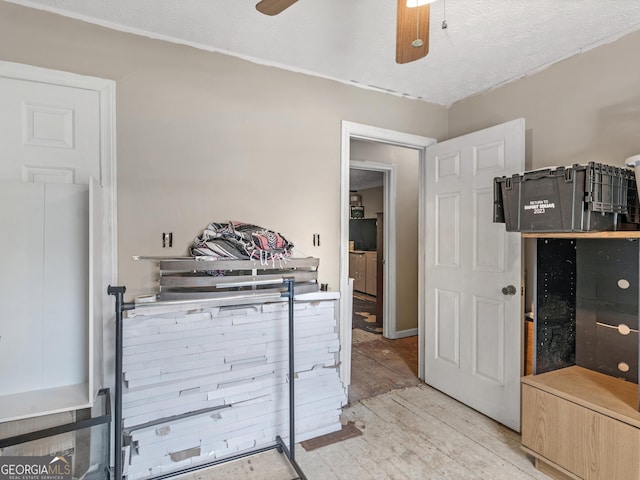 interior space with ceiling fan