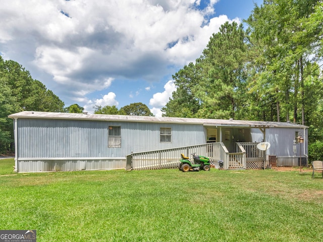 rear view of property featuring a lawn