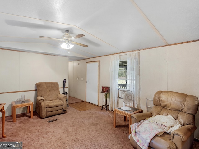 living area with light carpet, vaulted ceiling, and ceiling fan