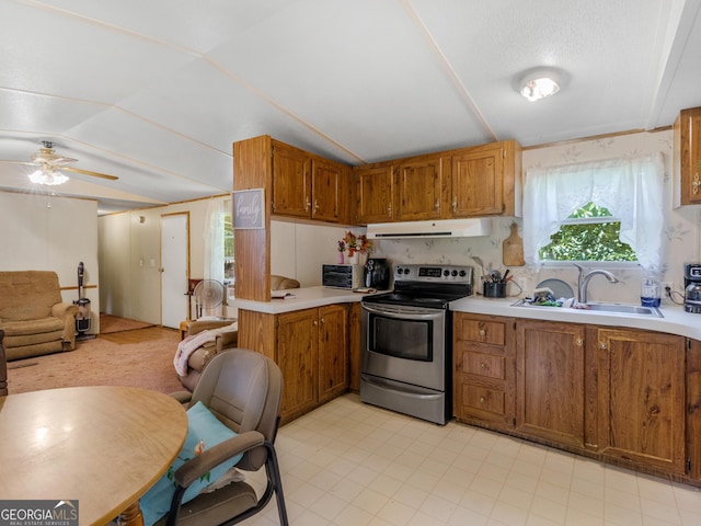 kitchen with vaulted ceiling, sink, stainless steel range with electric cooktop, and ceiling fan