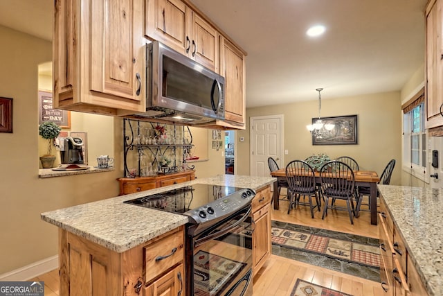 kitchen with black / electric stove, light stone countertops, a chandelier, and light wood-type flooring