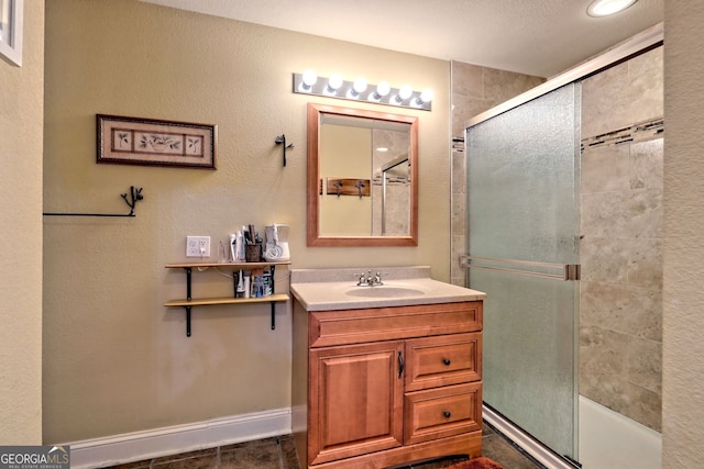 bathroom featuring vanity, tile patterned flooring, and a textured ceiling