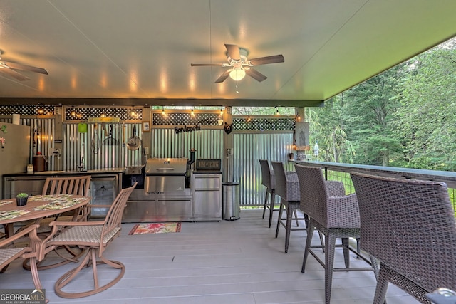 wooden terrace with grilling area and ceiling fan