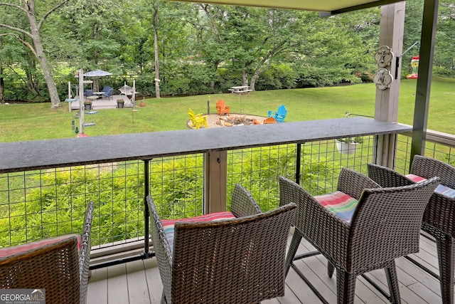 wooden terrace with a lawn