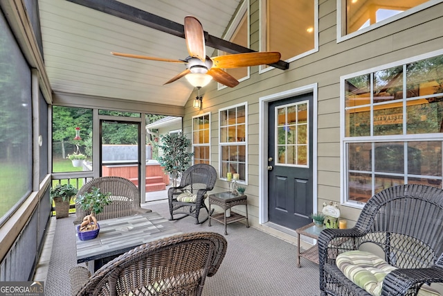 sunroom with ceiling fan and lofted ceiling