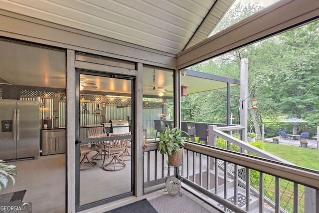 sunroom / solarium with vaulted ceiling