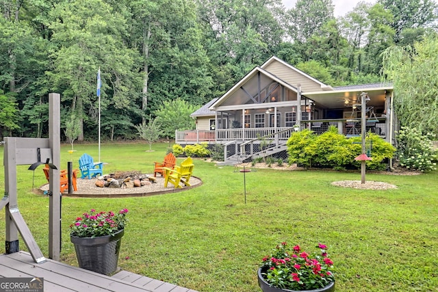 view of yard with a sunroom and a deck