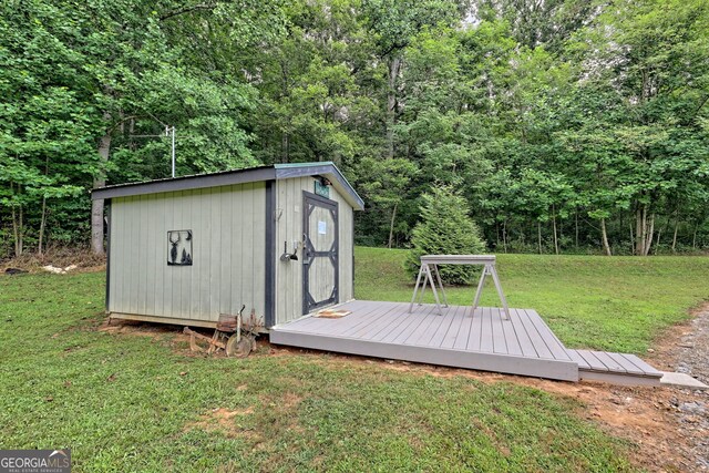 view of outbuilding featuring a lawn