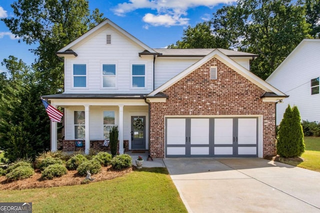 front of property with a garage, a porch, and a front yard