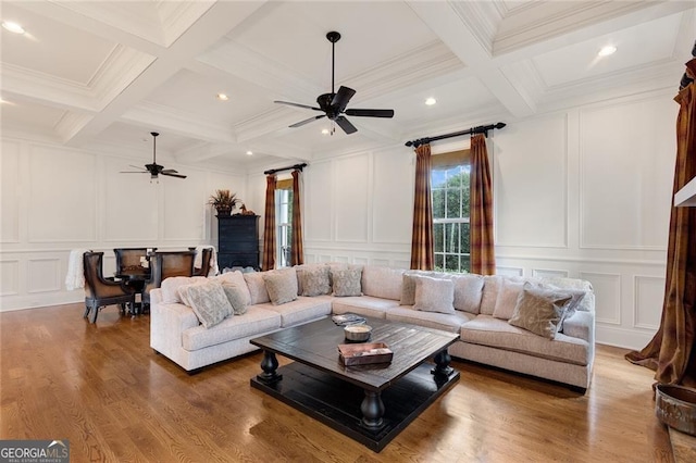 living room with ceiling fan, beamed ceiling, coffered ceiling, and hardwood / wood-style floors