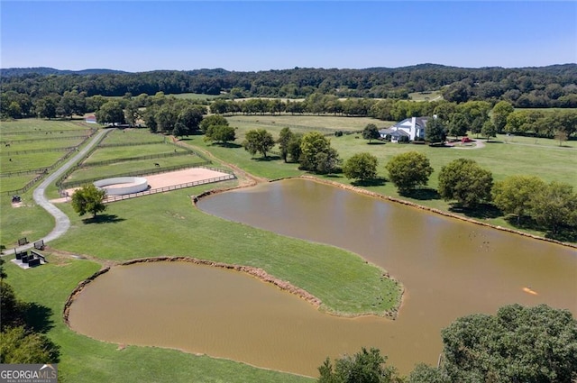 birds eye view of property featuring a water view and a rural view