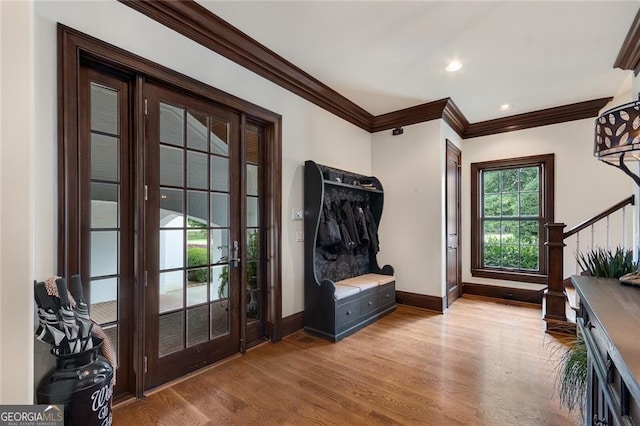 interior space featuring ornamental molding and light wood-type flooring