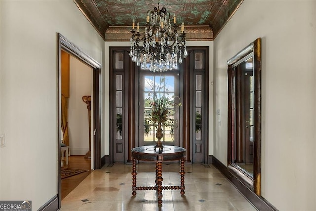 doorway to outside featuring an inviting chandelier, ornamental molding, and beam ceiling