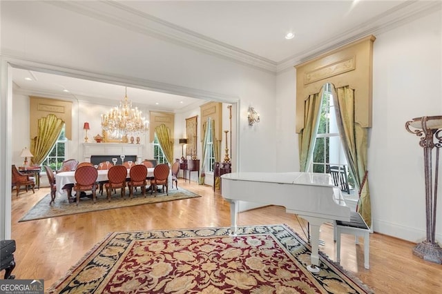 interior space featuring a chandelier, ornamental molding, and light hardwood / wood-style floors