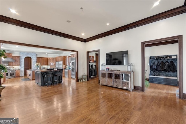 living room featuring ornamental molding and light wood-type flooring