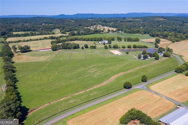 drone / aerial view featuring a water and mountain view and a rural view