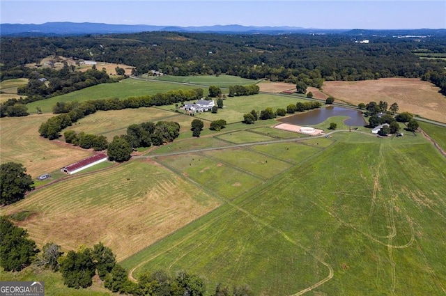 birds eye view of property with a rural view and a water view