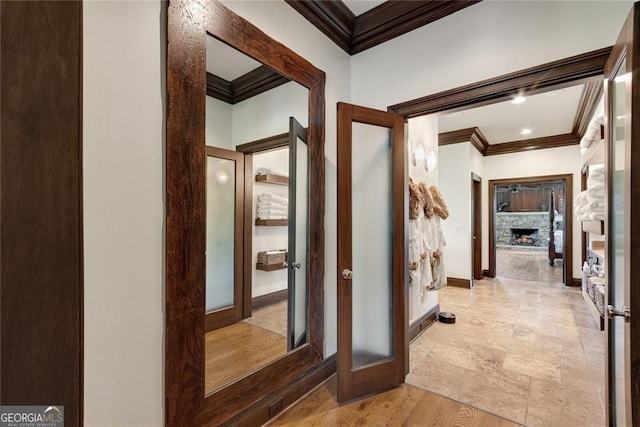 hall with french doors, ornamental molding, and light hardwood / wood-style floors