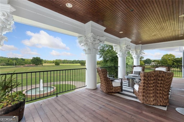 wooden terrace with a lawn