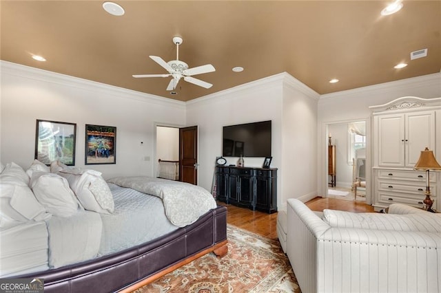 bedroom with ceiling fan, light hardwood / wood-style flooring, and ornamental molding