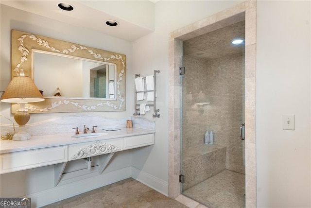 bathroom featuring vanity and an enclosed shower